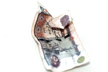 Selective focus of crumpled Egyptian money of 50 LE fifty pounds isolated on white background,...