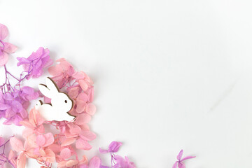 Easter spring flowers and rabbit. Holiday decoration background with copy space, flat lay, top view photo