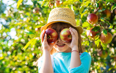 Child with Child with an apple. Selective focus. Garden