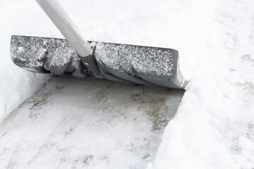 Snow cleaning with a large shovel in winter - 488169012