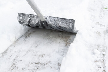 Snow cleaning with a large shovel in winter - 488169020