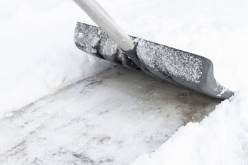 Snow cleaning with a large shovel in winter - 488169033