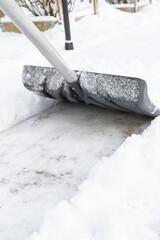 Snow cleaning with a large shovel in winter - 488169034