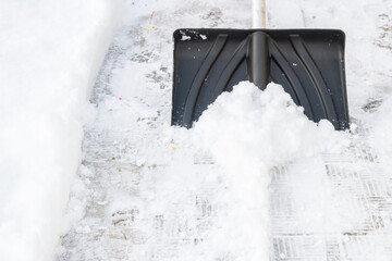 Snow cleaning with a large shovel in winter - 488169205