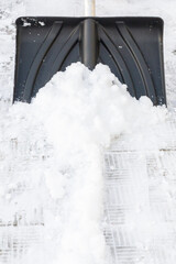 Snow cleaning with a large shovel in winter - 488169254