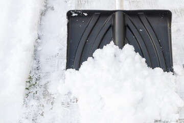 Snow cleaning with a large shovel in winter - 488169261