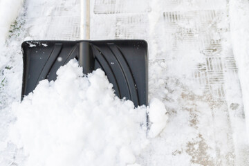 Snow cleaning with a large shovel in winter - 488169277