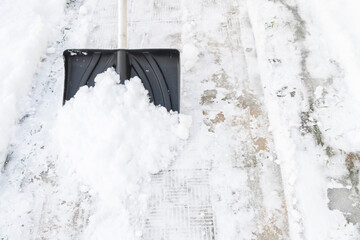 Snow cleaning with a large shovel in winter - 488169285