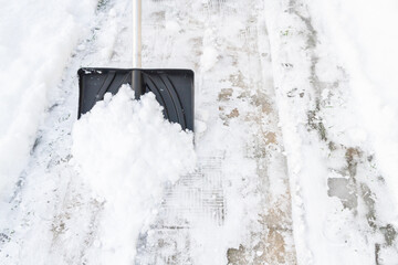 Snow cleaning with a large shovel in winter - 488169298