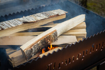 Dry wood in the grill for kindling and making coals - 488169836