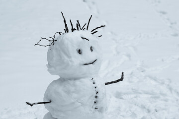 Big ugly snowman in winter. Snowman with creepy face and hair