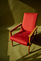 red chair on olive green background
