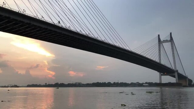 4K Timelapse , Beautiful clouds over Kolkata city with a view of Vidyasagar Setu or Second Hooghly Bridge on the river Ganges , West Bengal, India.