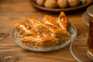 Baklava with nuts on a wooden background. Selective focus.
