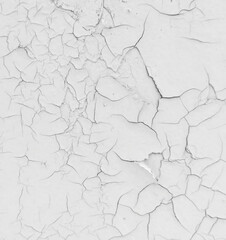 Cracked white paint on the wall as an abstract background.