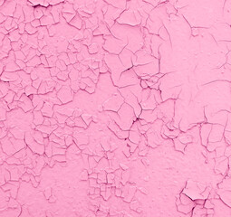 Cracked pink paint on the wall as an abstract background.