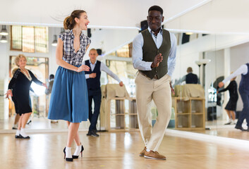 Woman and man dancing swing in studio