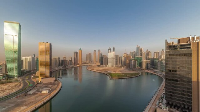 Cityscape skyscrapers of Dubai Business Bay with water canal aerial timelapse.