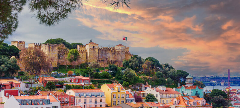 Panorama of the Lisbon city and Castelo de Sao Jorge, known as the Saint George historical castle, at sunset