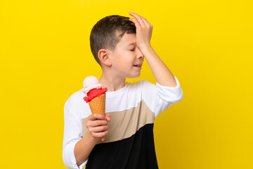 Little caucasian boy with a cornet ice cream isolated on yellow background has realized something and intending the solution