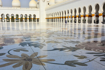 Sheikh Zayed Grand Mosque, courtyard of world's largest mosque located i.n Abu Dhabi, in United Arab Emirates; arabesque flower patterns on floor