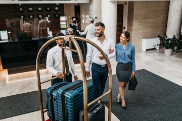 People at the reception of a hotel checking in. Business trip.