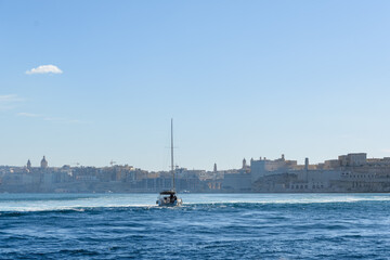 A sailing boat on the Grand Harbour,  sailing towards Fort Saint Angelo in Birgu (Vittoriosa), Malta.