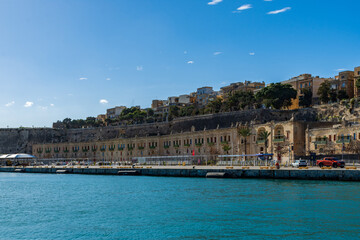 In front of the Floriana Lines fortifications are the old stores and warehouses at the Valletta...
