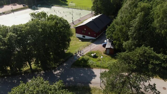 Aerial top-down forward over green area around soccer field at Lovgardet, Gothenburg in Sweden