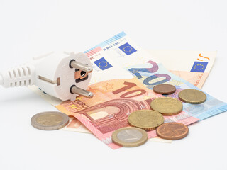 Electric power plug and Euro money on white background