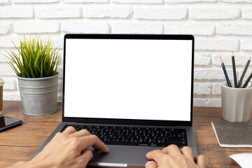 mock up empty screen notebook, businessman working on his laptop computer with blank space screen for advertising text on wood desk in office