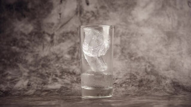 Ice melting. Fast melting video of ice in a glass. Ice quickly turns into water. water solubility concept