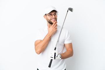 Handsome young man playing golf  isolated on white background looking up while smiling