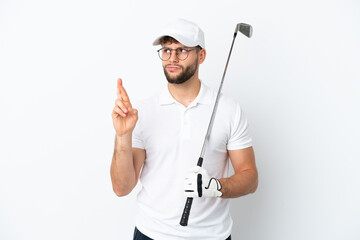Handsome young man playing golf  isolated on white background with fingers crossing and wishing the best