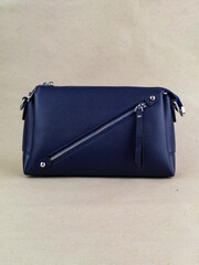 A beautiful women's bag stands on a paper background.