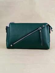 A beautiful women's bag stands on a paper background.