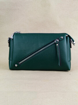 A beautiful women's bag stands on a paper background.