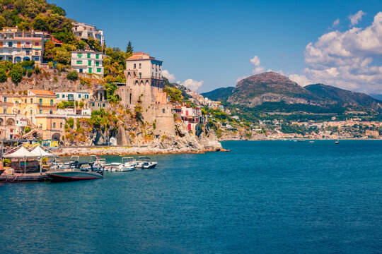 Impressive summer view of historical landmark - Torre di Cetara tower. Wonderful morning cityscape of Cetara town. Colorful Mediterranean seascape. Vacation concept background.