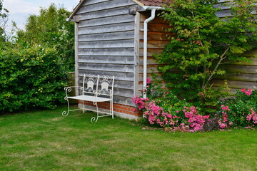 wooden shed with flowers in a garden
