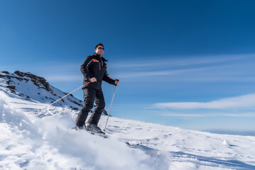 Fototapeta na wymiar Skier sliding down the mountain on the snow in the ski resort