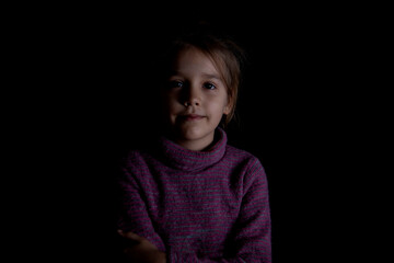 Cute little girl on a black background