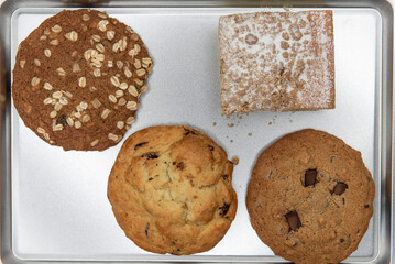 Variety of baked items on a cookie tray and fresh from the warm oven and ready to eat