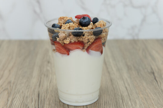 Complete meal contained in this cup of yogurt, blueberries, strawberries, and granola for plenty of protein and carbohydrates to eat