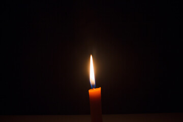 Close-up of a woman's hand lit a match candle in the dark as it burned, and after a gust of wind...