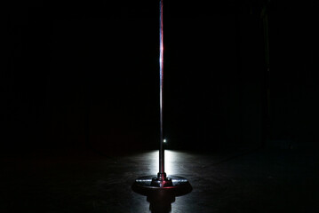 Pole dance in studio at black background. Striptease night club.