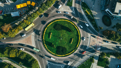 Top view of traffic and people, cars and buses at rush hour at circular junction