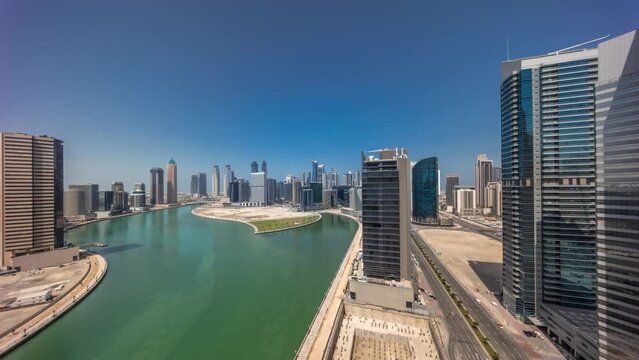 Cityscape skyscrapers of Dubai Business Bay with water canal aerial timelapse.