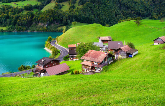 Lungern, canton of Obwalden, Switzerland. A view of rural homes in a green meadow. A lake in a mountain valley. A popular place to travel.