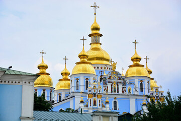 Fototapeta na wymiar St Michael's Golden Domed Monastery; Golden Cupolas of Orthodox Cathedral. in Ukraine; dedicated to Archangel Michael, patron saint of Kiev