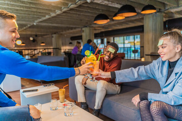 Doing a cheers with their drinks